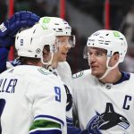 
              Vancouver Canucks center J.T. Miller (9), and teammates Alex Chiasson (39) and Bo Horvat (53) celebrate a goal against the Ottawa Senators during the third period of an NHL hockey game, Wednesday, Dec.1, 2021 in Ottawa, Ontario. (Sean Kilpatrick/The Canadian Press via AP)
            