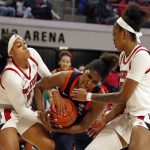 
              Virginia's Eleah Parker, center, tries to control the ball between North Carolina State's Jakia Brown-Turner, left, and Jada Boyd, right, during the first half of an NCAA college basketball game, Sunday, Dec. 19, 2021, in Raleigh, N.C. (AP Photo/Karl B. DeBlaker)
            