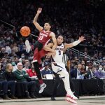 
              Alabama's Jahvon Quinerly, left, and Gonzaga's Andrew Nembhard (3) collide while chasing the ball during the first half of an NCAA college basketball game Saturday, Dec. 4, 2021, in Seattle. (AP Photo/Elaine Thompson)
            