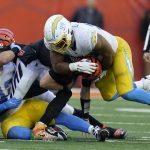
              Cincinnati Bengals quarterback Joe Burrow (9) is sacked by Los Angeles Chargers' Jerry Tillery (99) during the second half of an NFL football game, Sunday, Dec. 5, 2021, in Cincinnati. (AP Photo/Michael Conroy)
            