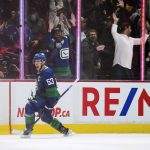 
              Vancouver Canucks' Bo Horvat celebrates after scoring the winning goal against the Columbus Blue Jackets during the third period of an NHL hockey game Tuesday, Dec. 14, 2021 in Vancouver, British Columbia. (Darryl Dyck/The Canadian Press via AP)
            