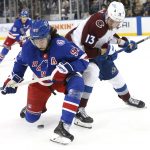 
              New York Rangers center Mika Zibanejad (93) and Colorado Avalanche right wing Valeri Nichushkin (13) battle for the puck during the first period of an NHL hockey game, Wednesday, Dec. 8, 2021, in New York. (AP Photo/Noah K. Murray)
            