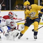 
              Montreal Canadiens goaltender Jake Allen (34) blocks a shot by Nashville Predators left wing Filip Forsberg (9) during the second period of an NHL hockey game Saturday, Dec. 4, 2021, in Nashville, Tenn. (AP Photo/Mark Zaleski)
            