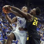 
              Kentucky's Oscar Tshiebwe (34) shoots while pressured by Missouri's Kobe Brown (24) during the first half of an NCAA college basketball game in Lexington, Ky., Wednesday, Dec. 29, 2021. (AP Photo/James Crisp)
            