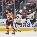
              Boston Bruins' Craig Smith (12), Matt Grzelcyk (48) and Jake DeBrusk (74) celebrate a goal as Edmonton Oilers' Devin Shore (14) skates off during second-period NHL hockey game action in Edmonton, Alberta, Thursday, Dec. 9, 2021. (Amber Bracken/The Canadian Press via AP)
            