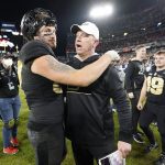 
              Purdue head coach Jeff Brohn celebrates with tight end Payne Durham, left, after Purdue beat Tennessee in overtime in the Music City Bowl NCAA college football game Thursday, Dec. 30, 2021, in Nashville, Tenn. Purdue won 48-45. (AP Photo/Mark Humphrey)
            
