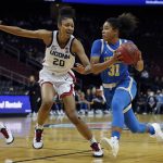 
              UCLA's Jaelynn Penn, right, drives to the basket as Connecticut's Olivia Nelson-Ododa defends during the first half of an NCAA college basketball game in Newark, N.J., Saturday, Dec. 11, 2021. (AP Photo/Noah K. Murray)
            