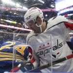 
              Washington Capitals right wing Daniel Spring fights for possession of the puck with Buffalo Sabres center Dylan Cozens (24) along the boards during the second period of an NHL hockey game Saturday, Dec. 11, 2021, in Buffalo, N.Y. (AP Photo/Joshua Bessex)
            