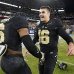 
              Purdue quarterback Aidan O'Connell (16) celebrates with linebacker Jalen Graham (6) after Purdue beat Tennessee in overtime in the Music City Bowl NCAA college football game Thursday, Dec. 30, 2021, in Nashville, Tenn. Purdue won 48-45. (AP Photo/Mark Humphrey)
            