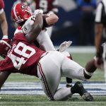 
              Alabama defensive lineman Phidarian Mathis (48) tackles Georgia quarterback Stetson Bennett (13) during the second half of the Southeastern Conference championship NCAA college football game, Saturday, Dec. 4, 2021, in Atlanta. (AP Photo/Brynn Anderson)
            