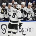 
              Los Angeles Kings defenseman Drew Doughty (8) celebrates with the bench after scoring against the Tampa Bay Lightning during the first period of an NHL hockey game Tuesday, Dec. 14, 2021, in Tampa, Fla. (AP Photo/Chris O'Meara)
            