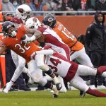 
              Chicago Bears running back David Montgomery (32) carries the ball and is tackled by Arizona Cardinals free safety Jalen Thompson (34) and Budda Baker during the first half of an NFL football game Sunday, Dec. 5, 2021, in Chicago. (AP Photo/David Banks)
            