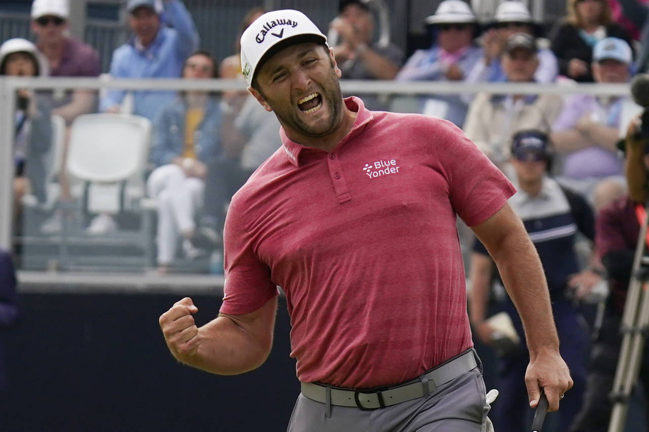 FILE - Jon Rahm, of Spain, reacts to making his birdie putt on the 18th green during the final roun...