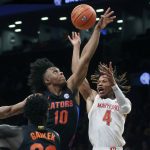 
              Maryland's Fatts Russell (4) has the ball knocked away by Florida's Elijah Kennedy (10) during the first half of an NCAA college basketball game Sunday, Dec. 12, 2021, in New York. (AP Photo/Jason DeCrow)
            