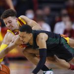 
              Iowa State guard Gabe Kalscheur (22) and Chicago State guard Brandon Betson (11) scramble for the ball during the first half of an NCAA college basketball game Tuesday, Dec. 21, 2021, in Ames, Iowa. (AP Photo/Matthew Putney)
            