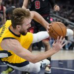 
              Indiana Pacers' Domantas Sabonis makes a pass as he falls during the first half of an NBA basketball game against the Chicago Bulls, Friday, Dec. 31, 2021, in Indianapolis. (AP Photo/Darron Cummings)
            