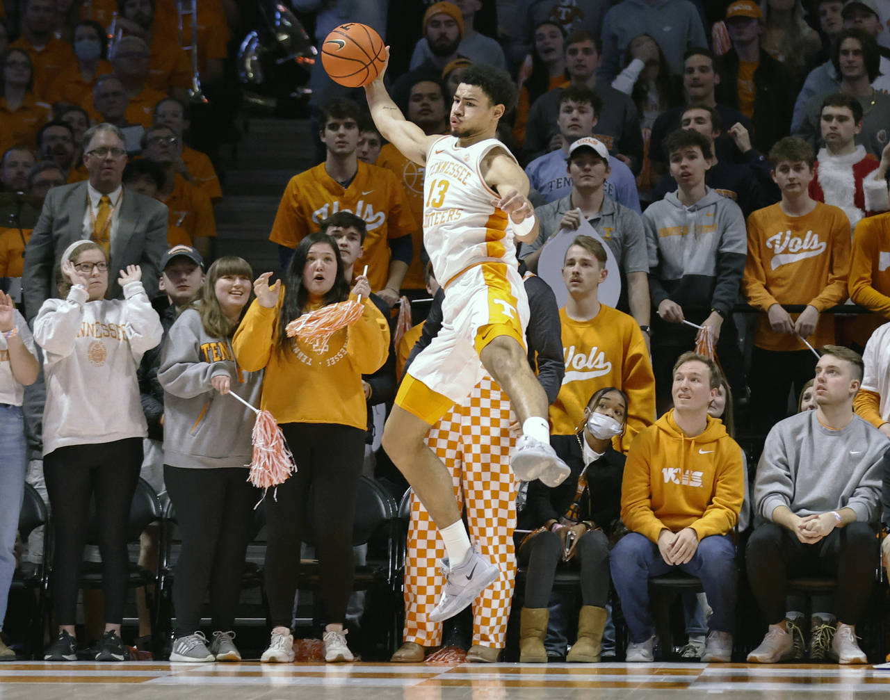 Tennessee forward Olivier Nkamhoua (13) saves the ball from going out of bounds during an NCAA coll...
