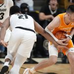 
              Tennessee forward John Fulkerson, right, recovers a loose ball as Colorado forward Evan Battey defends in the first half of an NCAA college basketball game Saturday, Dec. 4, 2021, in Boulder, Colo. (AP Photo/David Zalubowski)
            