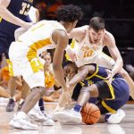 
              UNC-Greensboro guard Kobe Langley (3) battles for the ball with Tennessee forward John Fulkerson (10) and guard Kennedy Chandler (1) during an NCAA college basketball game Saturday, Dec. 11, 2021, in Knoxville, Tenn. (AP Photo/Wade Payne)
            