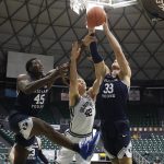 
              Vanderbilt forward Quentin Millora-Brown (42) goes for a rebound between BYU forward Fousseyni Traore (45) and BYU forward Caleb Lohner (33) in the first half of an NCAA college basketball game Thursday, Dec. 23, 2021, in Honolulu. (AP Photo/Marco Garcia)
            