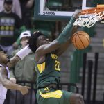 
              Baylor forward Jonathan Tchamwa Tchatchoua (23) dunks over Alcorn State guard Paul King in the second half of an NCAA college basketball game, Monday, Dec. 20, 2021, in Waco, Texas. (AP Photo/Rod Aydelotte)
            