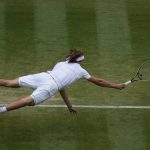 
              Germany's Alexander Zverev dives in an attempt to return the ball to Canada's Felix Auger-Aliassime during the men's singles fourth round match on day seven of the Wimbledon Tennis Championships in London, July 5, 2021. (AP Photo/Alastair Grant)
            