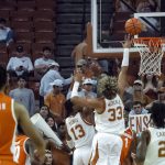 
              Texas forward Tre Mitchell (33) and Jase Febres (13) go up for a block on a shot by Texas Rio Grande Valley guard Justin Johnson (1) during the first half of an NCAA college basketball game, Friday, Dec. 3, 2021, in Austin, Texas. (AP Photo/Michael Thomas)
            