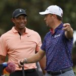 
              Tiger Woods talks with Justin Thomas on the 16th tee during the first round of the PNC Championship golf tournament Saturday, Dec. 18, 2021, in Orlando, Fla. (AP Photo/Scott Audette)
            