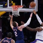 
              Los Angeles Lakers forward LeBron James (6) shoots against Brooklyn Nets forward Blake Griffin (2) during the first half of an NBA basketball game in Los Angeles, Saturday, Dec. 25, 2021. (AP Photo/Ashley Landis)
            