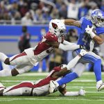 
              Detroit Lions running back Craig Reynolds is caught by Arizona Cardinals free safeties Jalen Thompson, top, and Deionte Thompson (22) during the second half of an NFL football game, Sunday, Dec. 19, 2021, in Detroit. (AP Photo/Lon Horwedel)
            