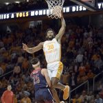 
              Tennessee's Josiah-Jordan James (30) dunks over Arizona's Kerr Kriisa (25) during the first half of an NCAA college basketball game Wednesday, Dec. 22, 2021, in Knoxville, Tenn. (Scott Keller/The Daily Times via AP)
            