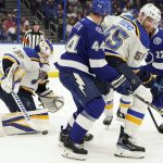 
              St. Louis Blues goaltender Ville Husso (35) makes a save on a shot by the Tampa Bay Lightning during the second period of an NHL hockey game Thursday, Dec. 2, 2021, in Tampa, Fla. Blues' Colton Parayko (55) keeps Lightning's Jan Rutta (44) from a rebound. (AP Photo/Chris O'Meara)
            