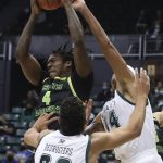 
              South Florida forward Jalyn McCreary (4) grabs a rebound over Hawaii forwards Jerome Desrosiers (22) and Kamaka Hepa (44) during the first half of an NCAA college basketball game Thursday, Dec. 23, 2021, in Honolulu. (AP Photo/Marco Garcia)
            