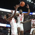 
              Houston center Josh Carlton (25) and forward J'Wan Roberts (13) reach for a rebound against Bryant during the first half of an NCAA college basketball game Friday, Dec. 3, 2021, in Houston. (AP Photo/Justin Rex)
            