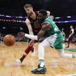 
              Boston Celtics' Jaylen Brown, right front, and Cleveland Cavaliers' Dean Wade vie for the ball during the first quarter of an NBA basketball game Wednesday, Dec. 22, 2021, in Boston. (AP Photo/Winslow Townson)
            