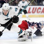 
              Columbus Blue Jackets' Elvis Merzlikins, right, makes a save as San Jose Sharks' Timo Meier trips during the first period of an NHL hockey game Sunday, Dec. 5, 2021, in Columbus, Ohio. (AP Photo/Jay LaPrete)
            