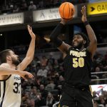 
              Purdue forward Trevion Williams (50) shoots over Butler forward Bryce Golden, left, during the second half of an NCAA college basketball game, Saturday, Dec. 18, 2021, in Indianapolis. (AP Photo/AJ Mast)
            