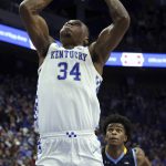 
              Kentucky's Oscar Tshiebwe (34) goes up for a dunk in front of Southern University's J'Quan Ewing (2) during the first half of an NCAA college basketball game in Lexington, Ky., Tuesday, Dec. 7, 2021. (AP Photo/James Crisp)
            