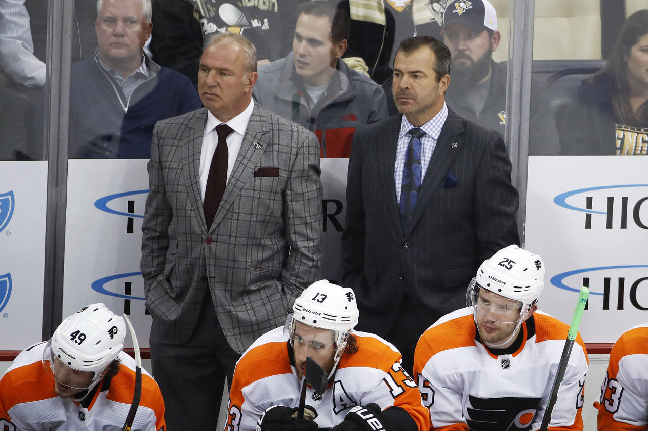 FILE - Philadelphia Flyers assistant Michel Therrien, left, and head coach Alain Vigneault stand be...