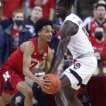 
              Nebraska's Alonzo Verge Jr. (1) gets around the pressure by N.C. State's Ebenezer Dowuona (21) during the first half of an NCAA college basketball game in Raleigh, N.C., Wednesday, Dec. 1, 2021. (Ethan Hyman/The News & Observer via AP)
            