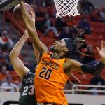 
              Oklahoma State guard Keylan Boone (20) blocks a shot by Cleveland State guard Broc Finstuen (23) in overtime of an NCAA college basketball game Monday, Dec. 13, 2021, in Stillwater, Okla. (AP Photo/Sue Ogrocki)
            