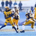 
              Kent State wide receiver Dante Cephas (14) turns away from Wyoming cornerback C.J. Coldon (21) after a reception during the first half of the Idaho Potato Bowl NCAA college football game, Tuesday, Dec. 21, 2021, in Boise, Idaho. (AP Photo/Steve Conner)
            