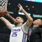 
              Sacramento Kings center Alex Len, left, shoots as Los Angeles Clippers guard Brandon Boston Jr. defends during the first half of an NBA basketball game Wednesday, Dec. 1, 2021, in Los Angeles. (AP Photo/Mark J. Terrill)
            