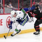 
              Vancouver Canucks center J.T. Miller (9) shoves his glove in the face of Ottawa Senators defenseman Thomas Chabot (72) during the third period of an NHL hockey game, Wednesday, Dec.1, 2021 in Ottawa, Ontario. (Sean Kilpatrick/The Canadian Press via AP)
            