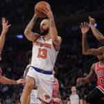 
              New York Knicks guard Evan Fournier (13) looks to move the ball around Chicago Bulls guard Alex Caruso (6) and forward Derrick Jones Jr. (5) in the first half of an NBA basketball game, Thursday, Dec. 2, 2021, at Madison Square Garden in New York. (AP Photo/Mary Altaffer)
            