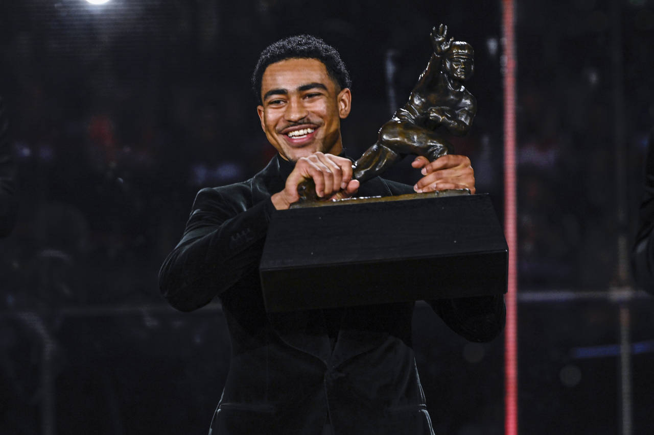 Alabama quarterback Bryce Young holds the Heisman Trophy at an award ceremony, Saturday, Dec. 11, 2...