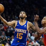
              Phoenix Suns guard Cameron Payne (15) drives past Oklahoma City Thunder guard Theo Maledon to score during the second half of an NBA basketball game Wednesday, Dec. 29, 2021, in Phoenix. (AP Photo/Ross D. Franklin)
            