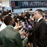 
              Mario Cristobal, right, is interviewed by the news media after being introduced as Miami's football coach during a news conference Tuesday, Dec. 7, 2021, in Coral Gables, Fla. Cristobal is returning to his alma mater, where he won two championships as a player. (AP Photo/Lynne Sladky)
            