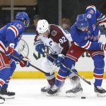 
              New York Rangers defenseman Jacob Trouba (8) and Colorado Avalanche left wing Gabriel Landeskog (92) battle for the puck during the second period of an NHL hockey game, Wednesday, Dec. 8, 2021, in New York. (AP Photo/Noah K. Murray)
            