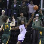 
              Alcorn State forward Keondre Montgomery (5) shoots between Baylor forward Flo Thamba, right, and Matthew Mayer, left, in the second half of an NCAA college basketball game, Monday, Dec. 20, 2021, in Waco, Texas. (AP Photo/Rod Aydelotte)
            